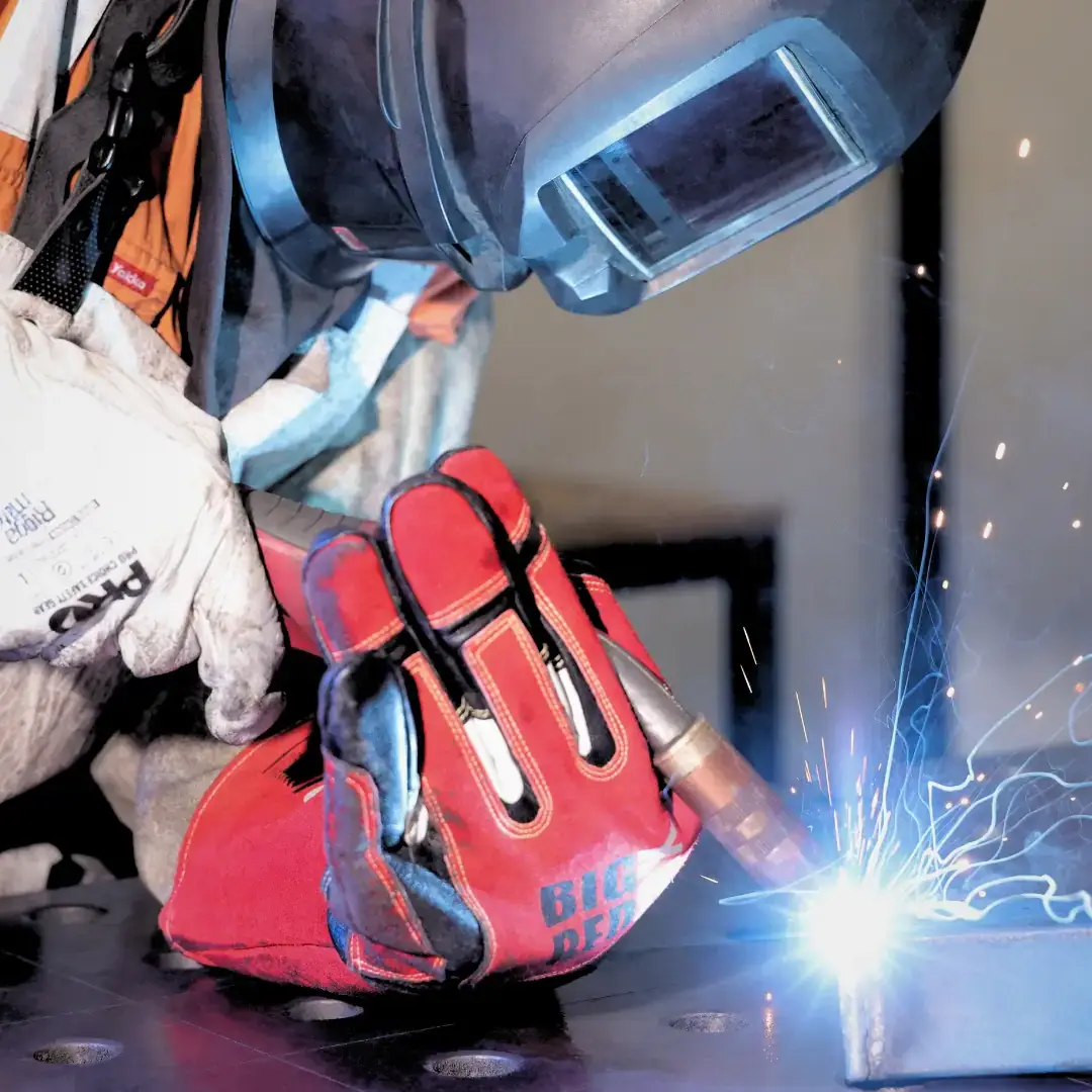 Welder completing fabrication on sheet metal.