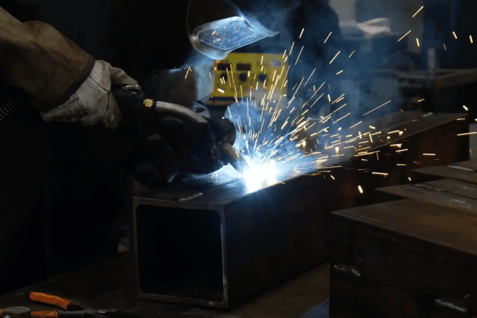 welder using a tig weld fabricating large metal beam