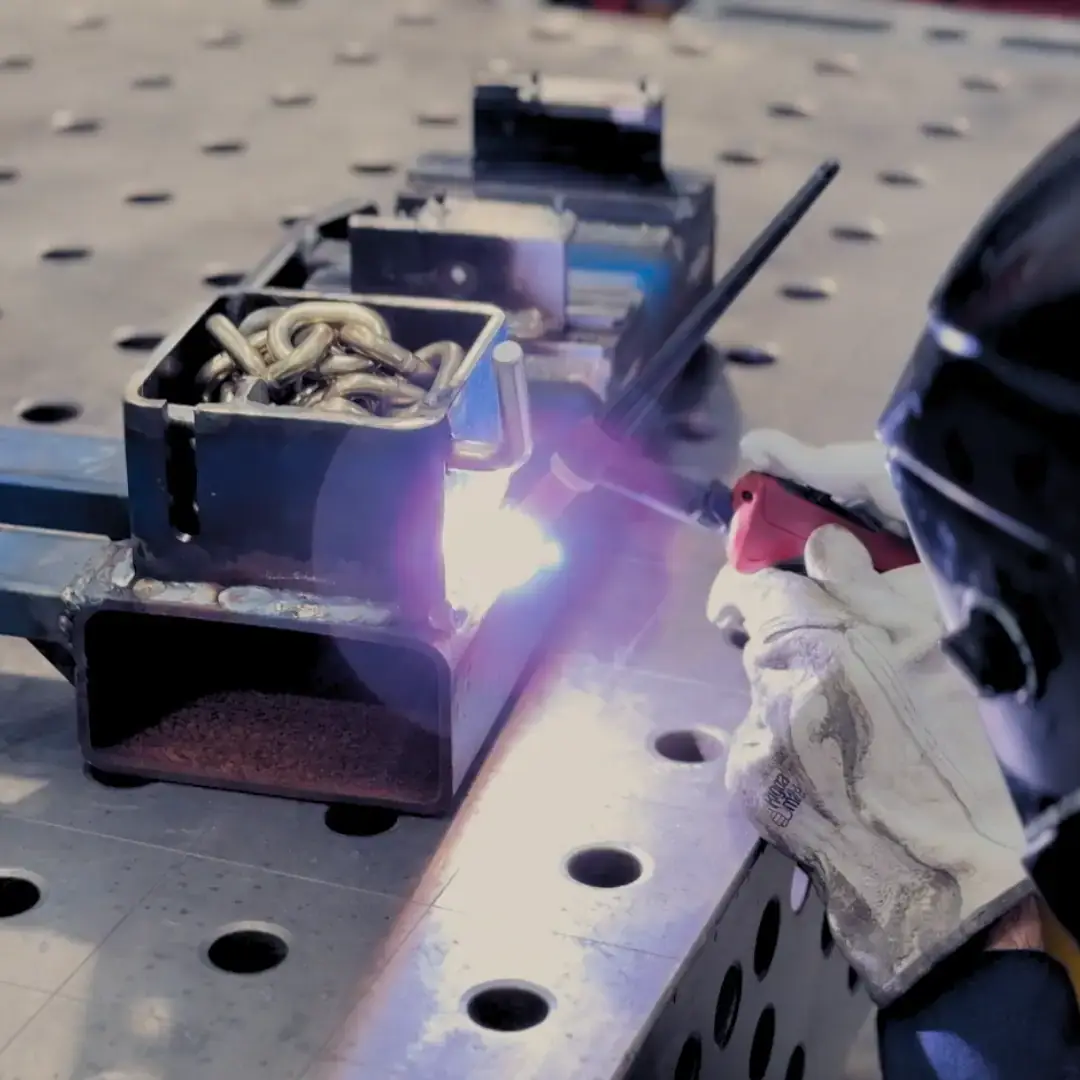 Welder welding together sheet metal using tig welding